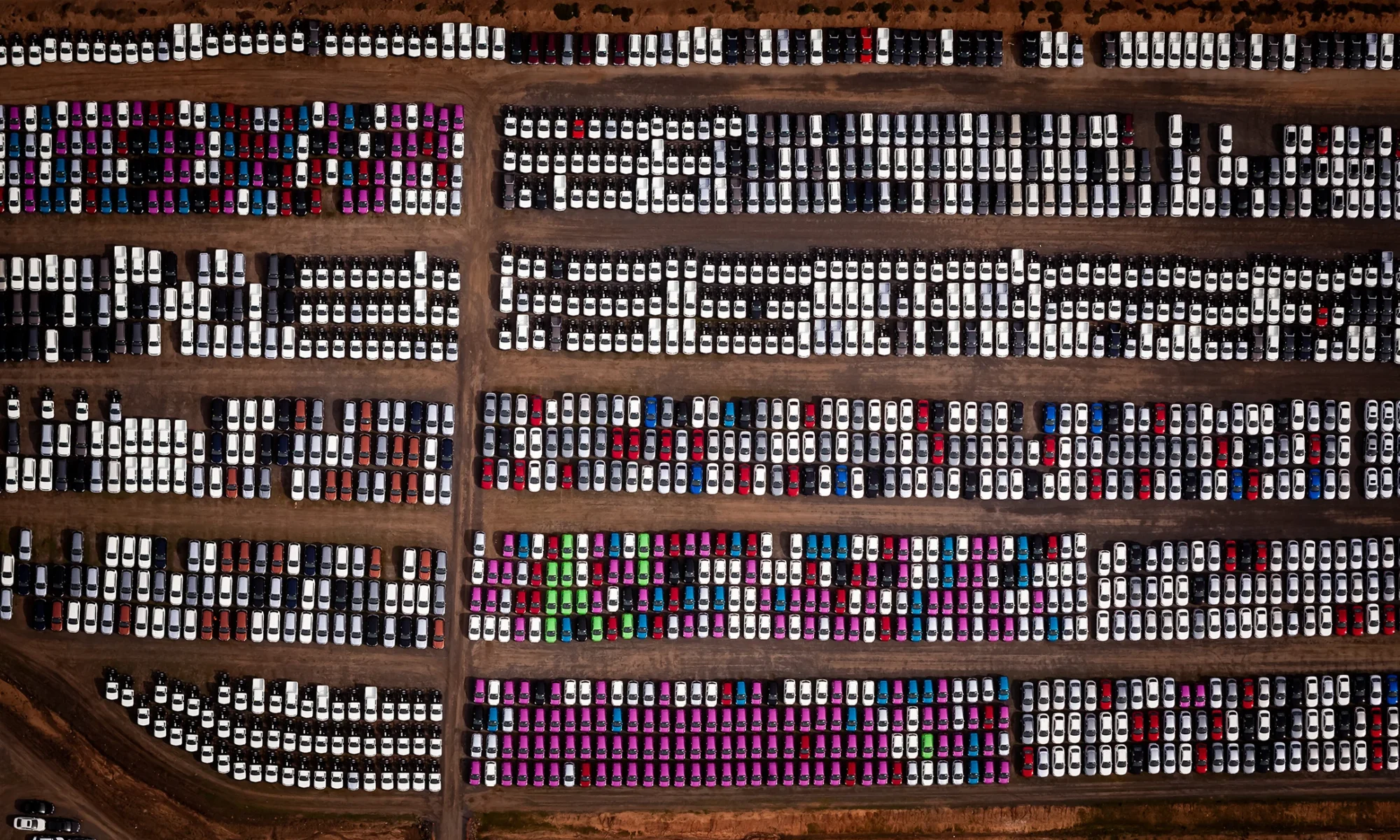 Vertical aerial view of new cars in a car lot